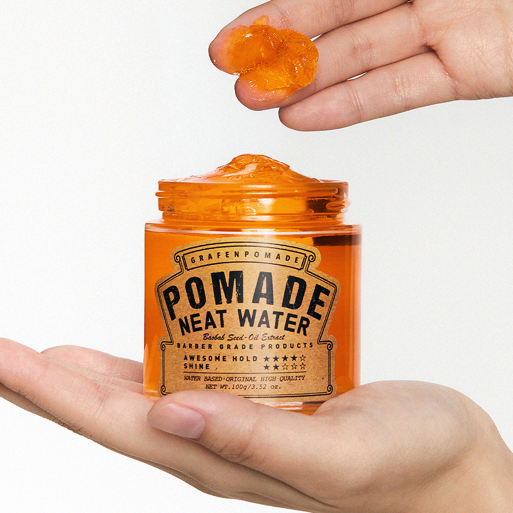 GRAFEN Pomande Neat Water 100g in open amber jar held by hands, glossy orange pomade scoop for men - Gentleman Korea