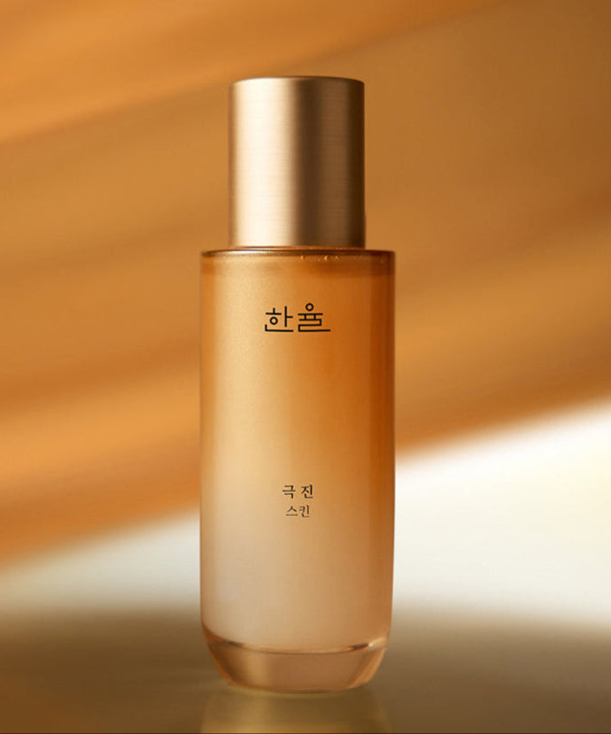 HANYUL Extreme Skin 125ml in a sleek bottle with a golden cap against a warm background.