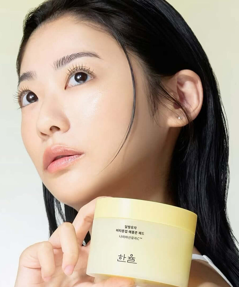 Woman holding HANYUL Moonlight Yuja Vita Tone Up Apple Zone Pad