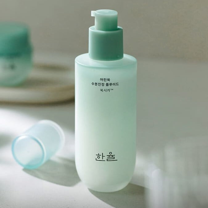 HANYUL Pure Artemisia pH-Balancing Fluid 125ml bottle on a table, ideal for hydrating and soothing sensitive skin.