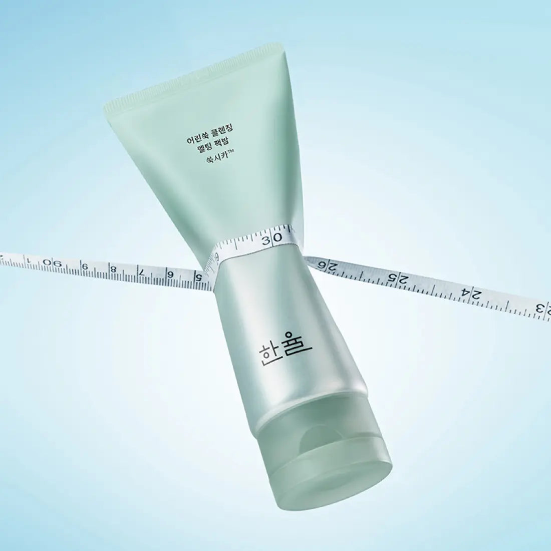 HANYUL Young Artemisia Cleansing Pack Balm 100g displayed against a blue background with a measuring tape.