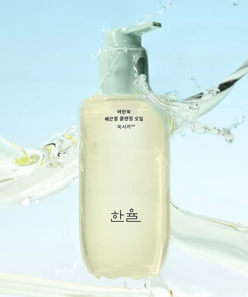 HANYUL Young Artemisia Smooth Cleansing Oil 200ml bottle with splash effect against a light blue background