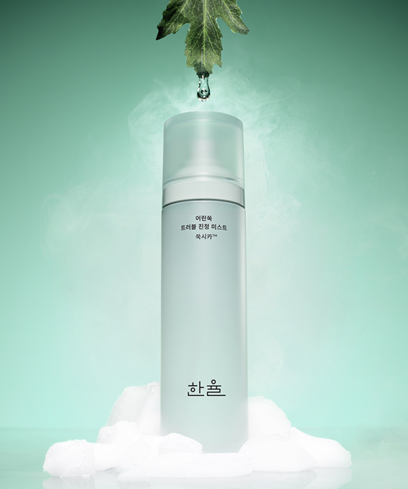 HANYUL Young Artemisia Trouble Mist 120ml product image with green herbal background and water droplet effect.