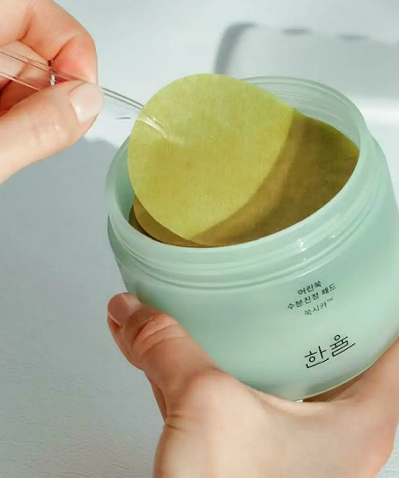 HANYUL Young Mugwort Moisturizing Soohting Pad being removed from green container for skincare use