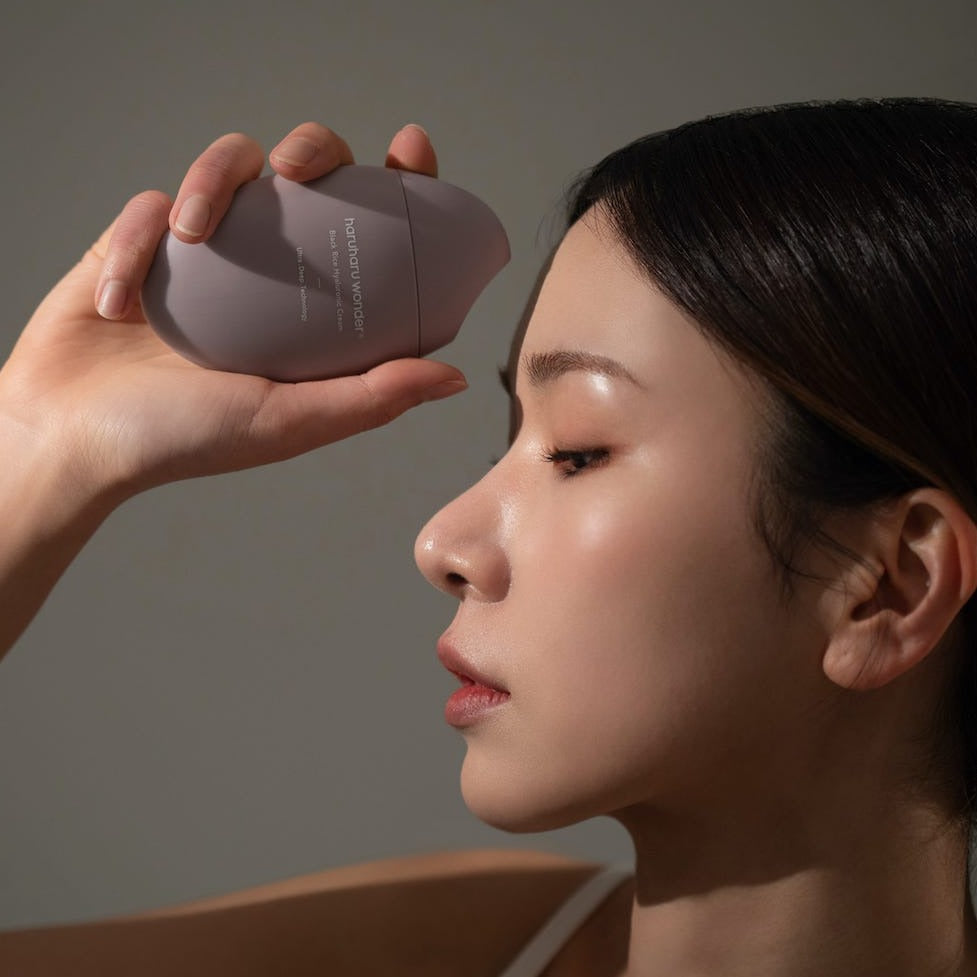 Woman holding HARUHARU Black Rice 10 Hyaluronic Cream 50ml