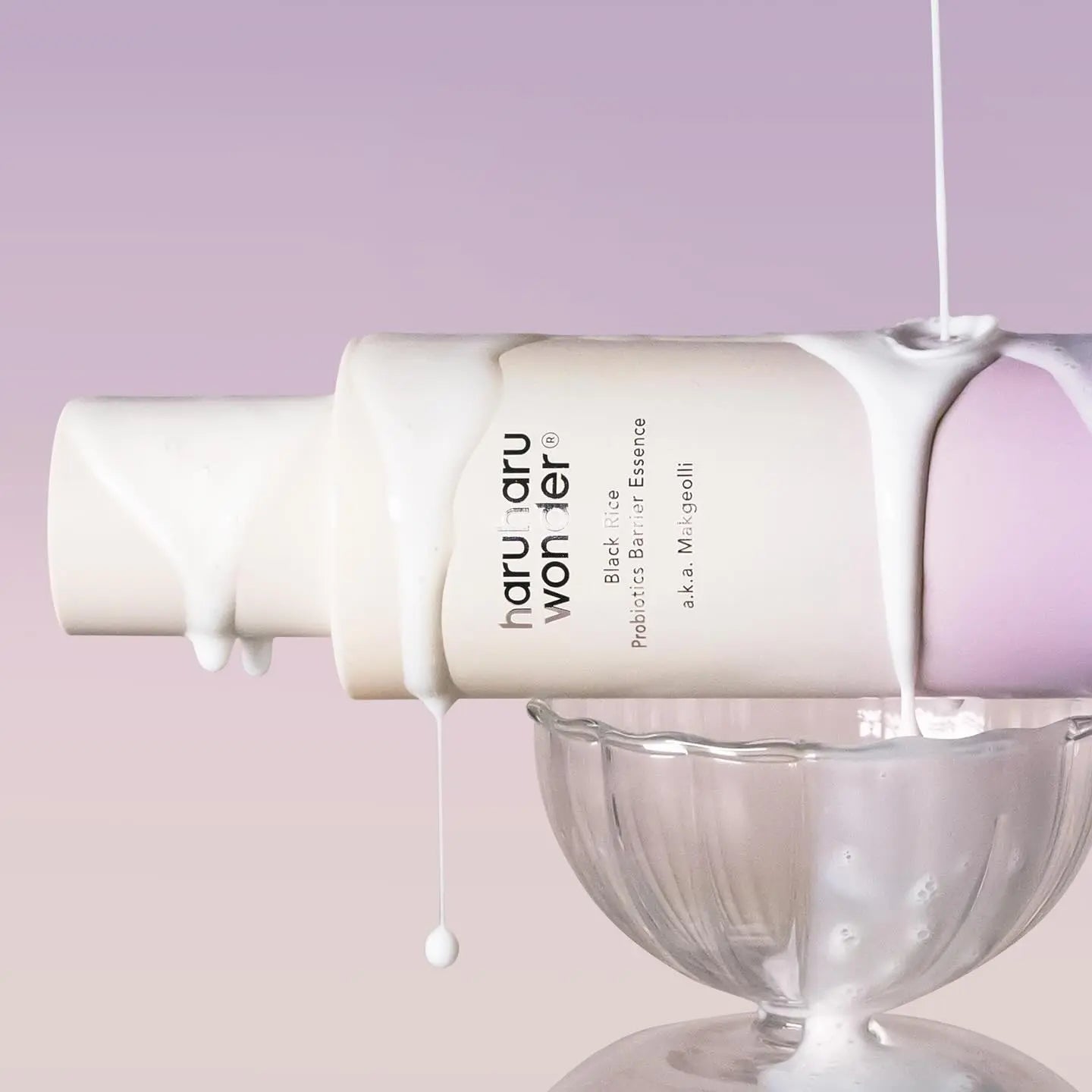 HARUHARU Black Rice Probiotics Barrier Essence 120ml bottle on display with white essence dripping into a glass bowl