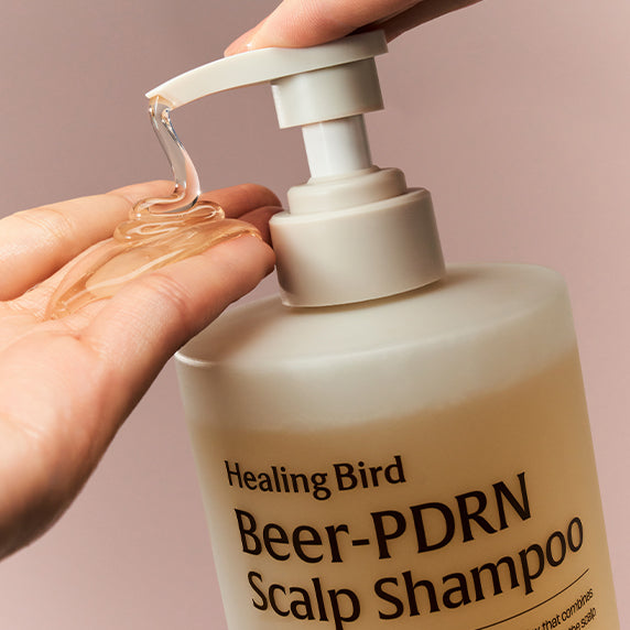 Pouring HEALING BIRD Beer PDRN Anti-Hair Loss Shampoo 1000ml from bottle pump onto hand