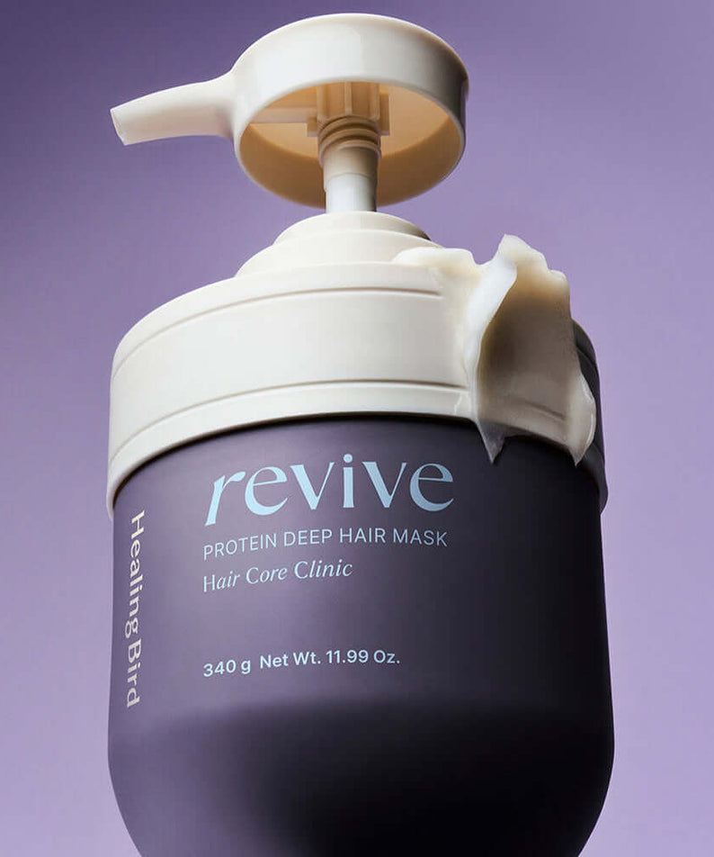 HEALING BIRD Revive Protein Shampoo + Deep Hair Mask bottle on purple background