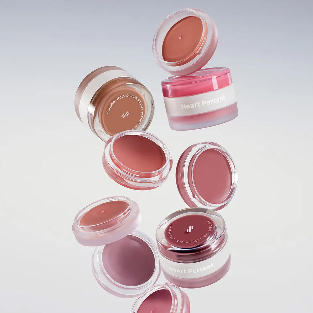 HEART PERCENT Dot On Mood Custom Lip & Cheek product containers floating against a neutral background.