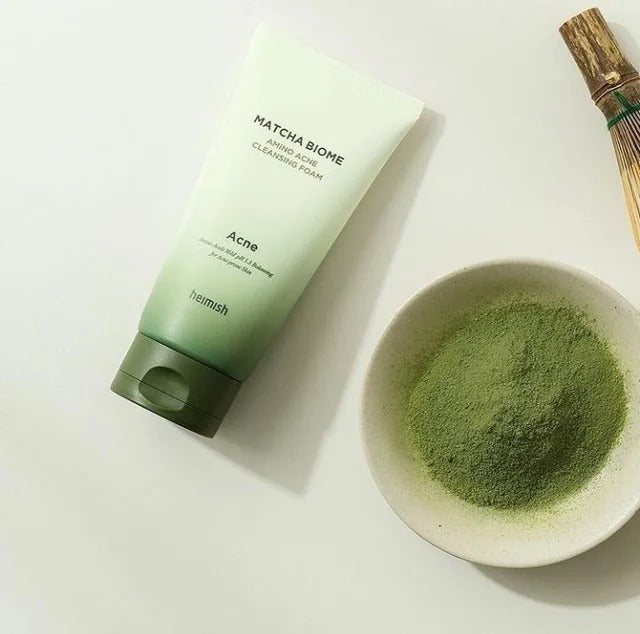 HEIMISH Matcha Biome Amino Acne Cleansing Foam 150g with matcha powder displayed next to it.