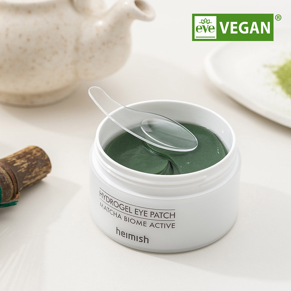 HEIMISH Matcha Biome Hydrogel Eye Patch 60p in open container showcasing green eye patches with applicator, vegan certified