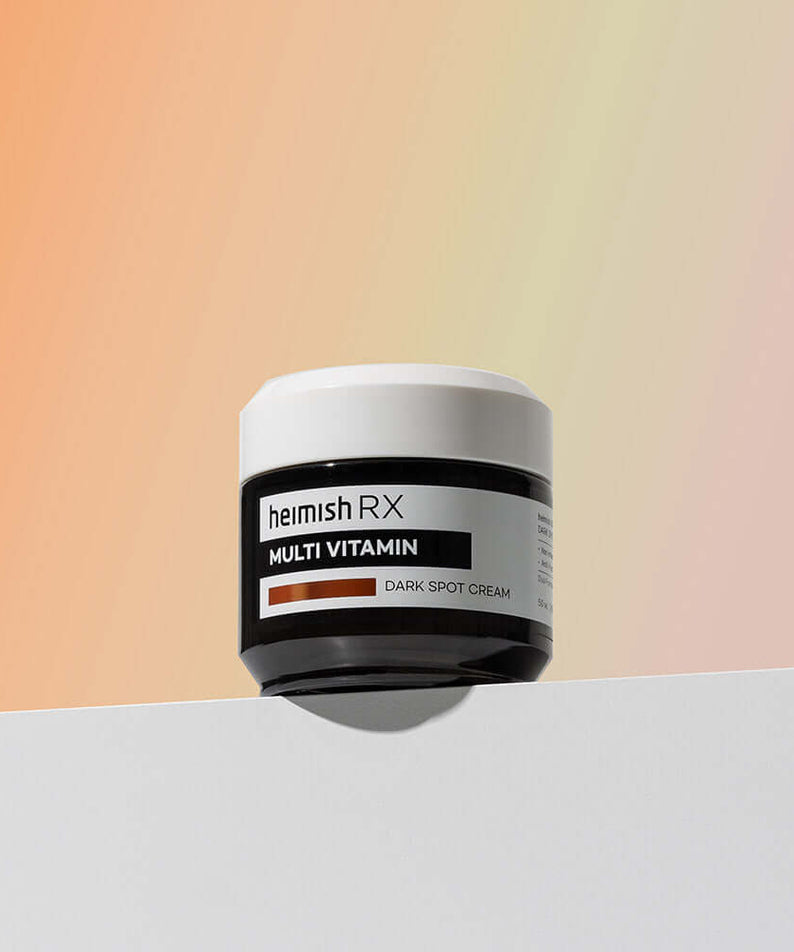 HEIMISH RX Multi Vitamin Dark Spot Cream 50ml jar on a gradient background