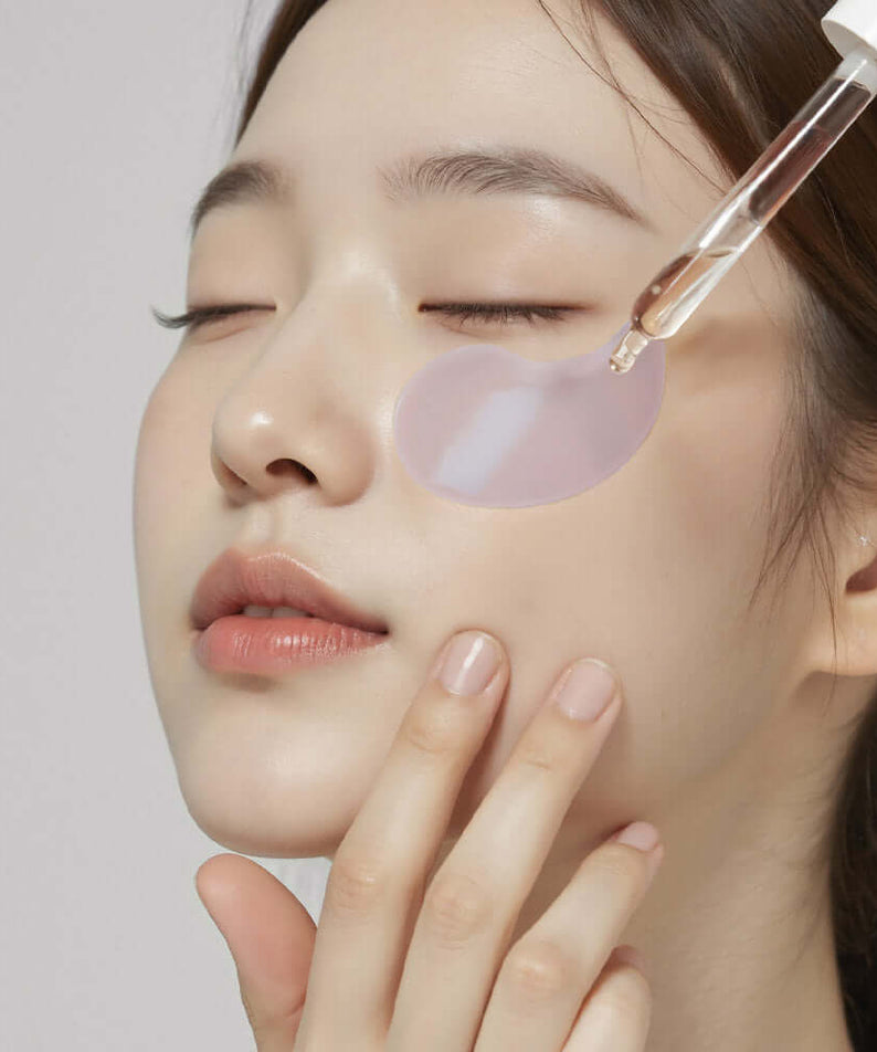 Woman applying HEIMISH RX Retinol Bakuchiol Hydrogel Eye Patches 60 Sheets for skincare