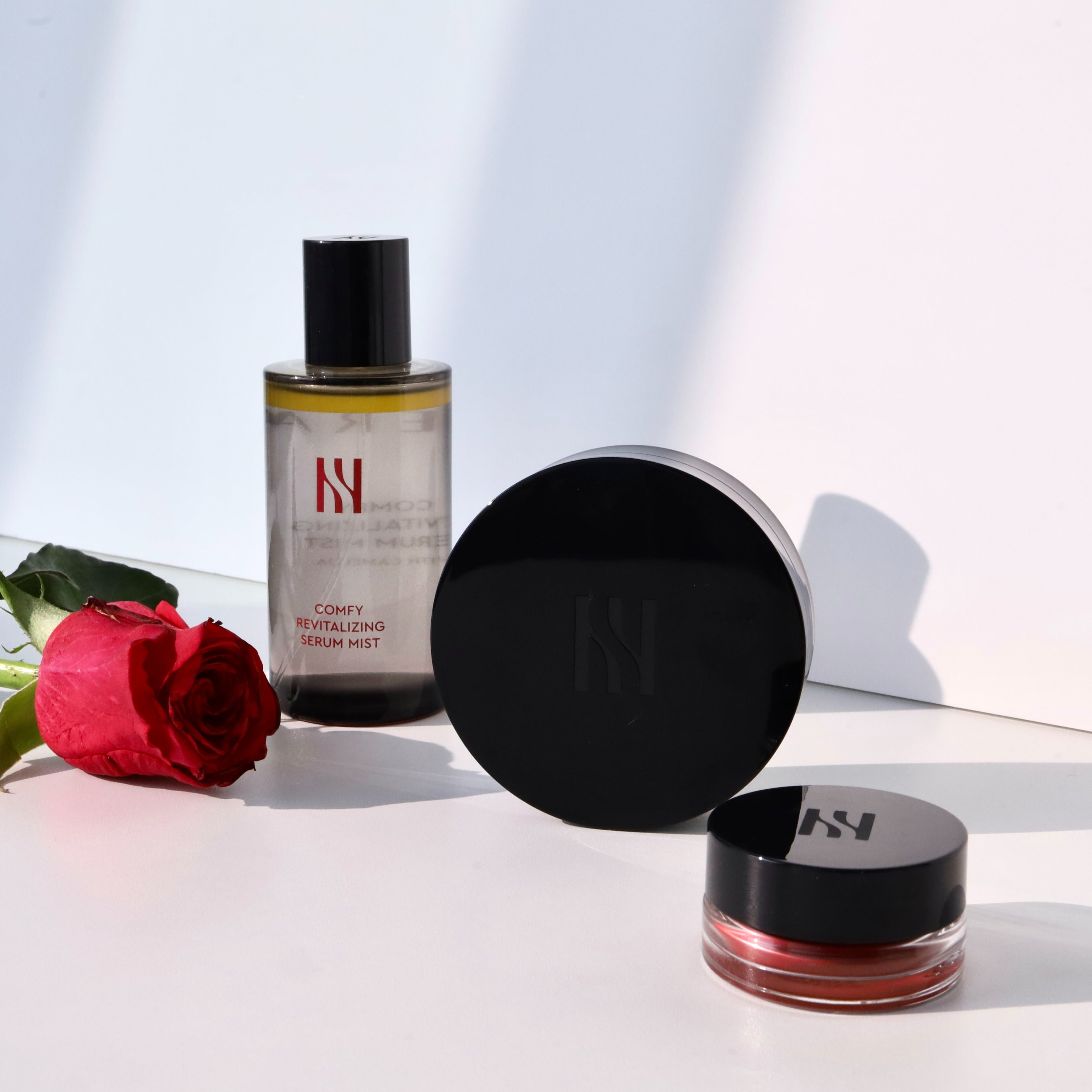 HERA Comfy Revitalizing Serum Mist 90ml with red rose in background