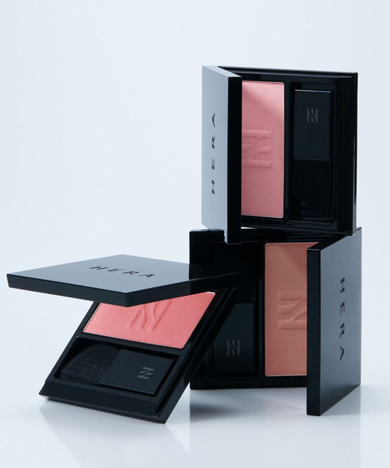 HERA Hera Blush 5.5g in black containers showcasing different shades of blush stacked creatively on a white background.