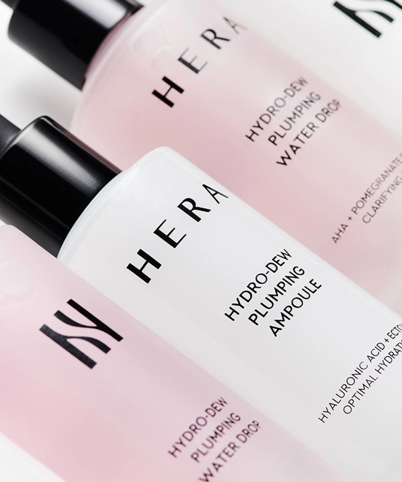 HERA Hydro-Dew Plumping Ampoule 50ml alongside other skincare products, emphasizing optimal hydration and plumping effect.