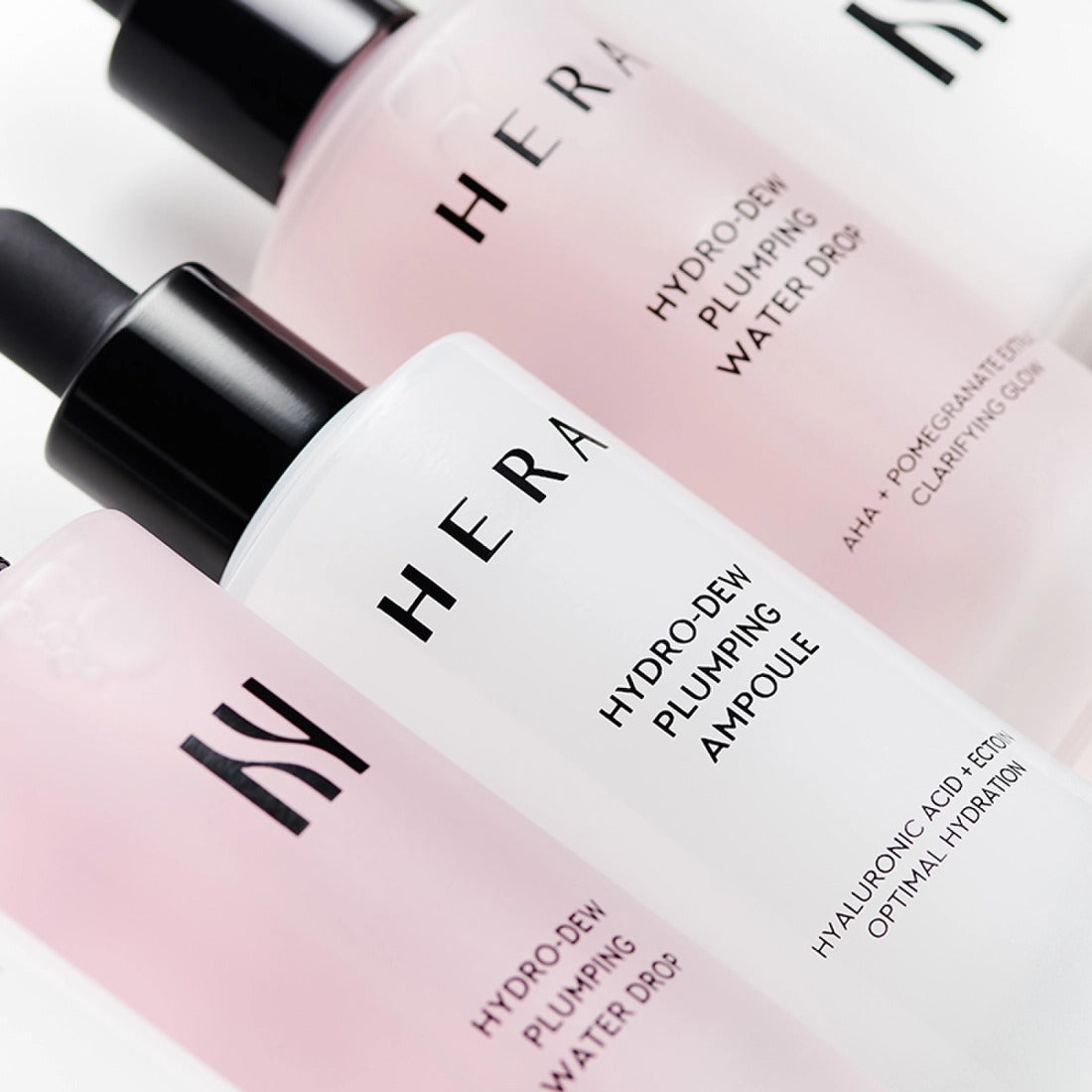 HERA Hydro-Dew Plumping Ampoule 50ml alongside other skincare products, emphasizing optimal hydration and plumping effect.