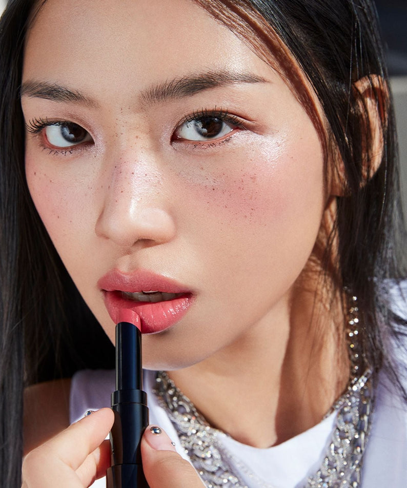 Woman applying HERA Sensual Tinted Shine Stick 3.5g lipstick