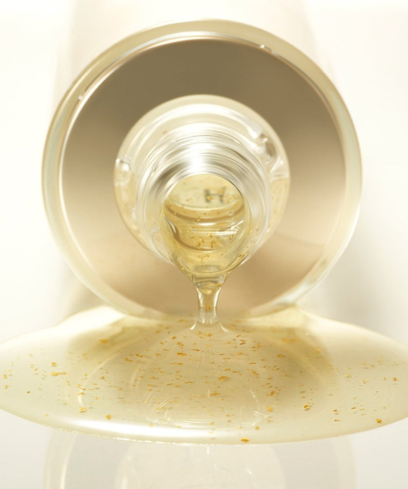 HERA Signa Skin refreshing Water 180ml pouring from bottle, showcasing its hydrating formula with visible particles on a light background.