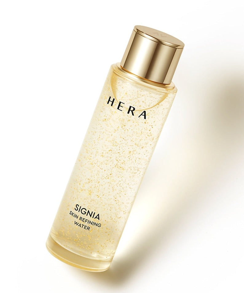 HERA Signa Skin refreshing Water 180ml bottle with golden cap on light background.