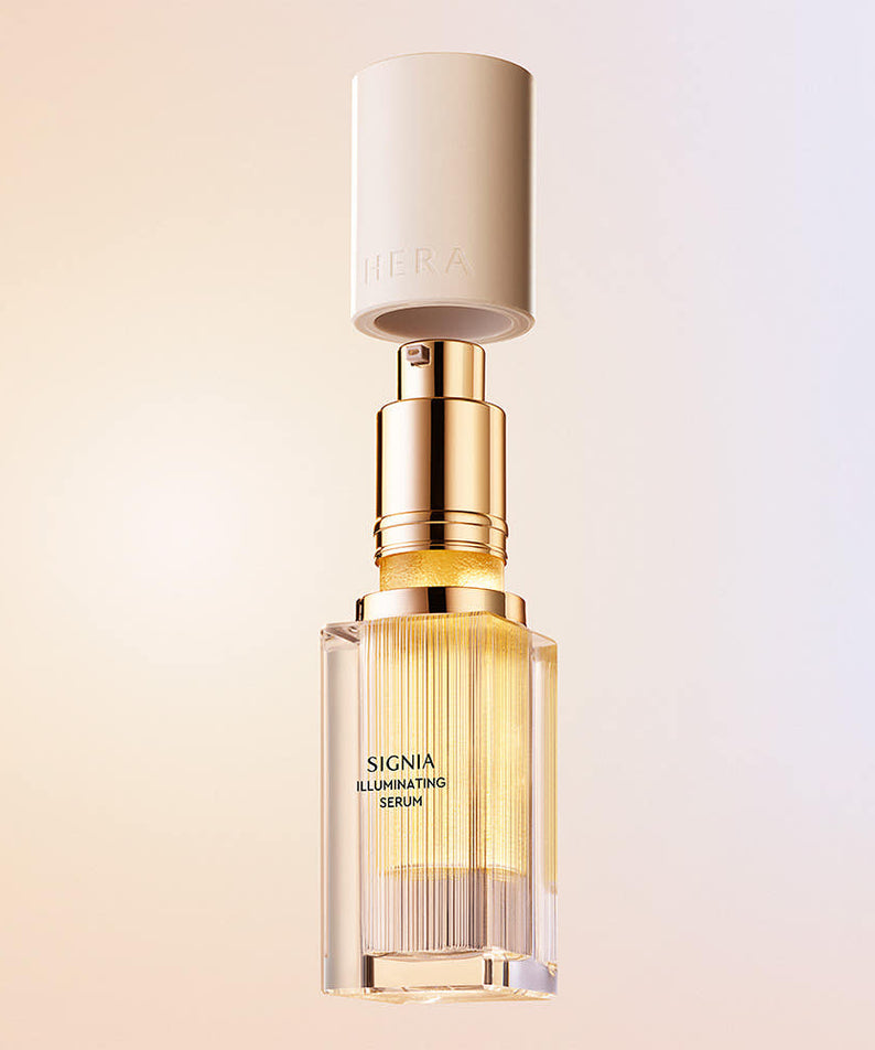 HERA Signia Illuminating Serum 30ml bottle with golden detailing, featuring luxury skincare packaging.
