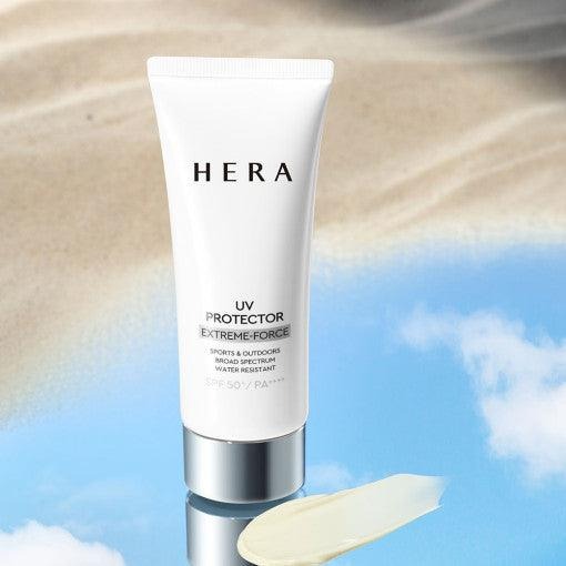 HERA UV Protector Extreme-Force Leports SPF50+PA++++ on sandy beach background with product swatch