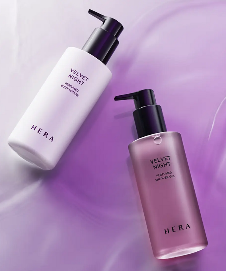 HERA Velvet Night Perfumed Shower Gel 250g bottle on a purple background with matching body lotion.