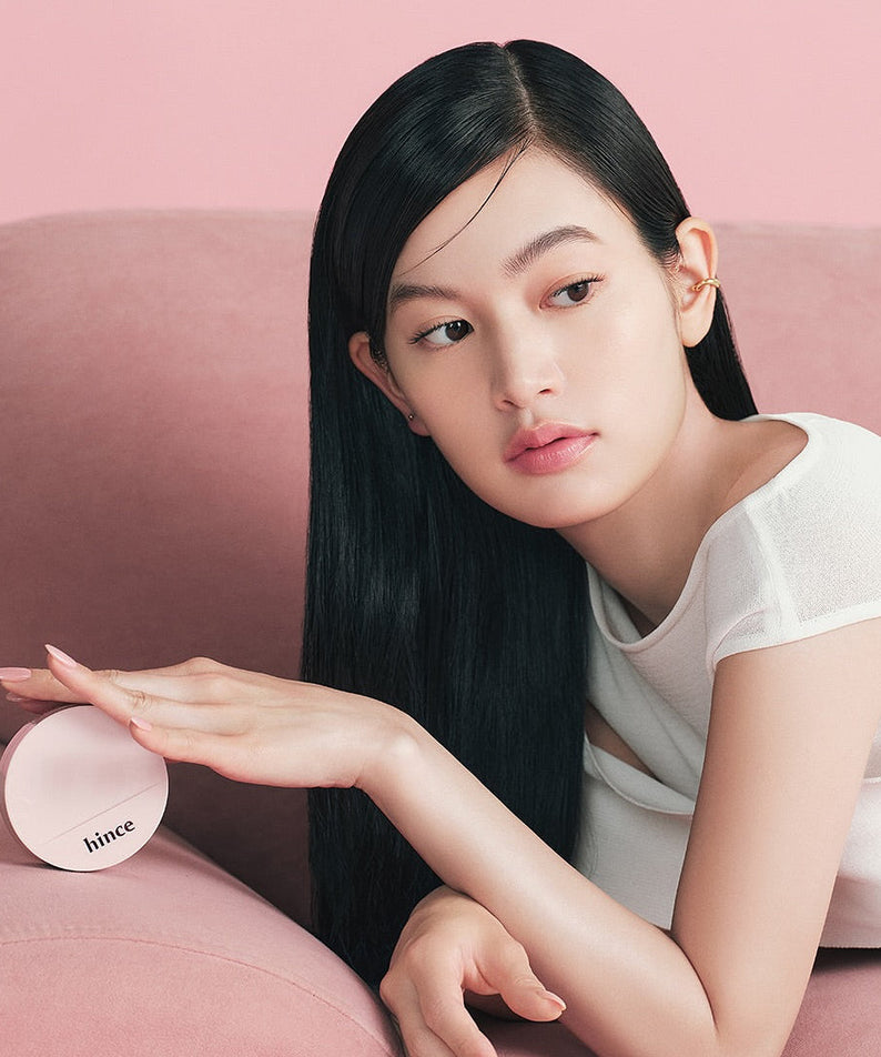 Model holding HINCE Cover Master Pink Cushion on a pink sofa