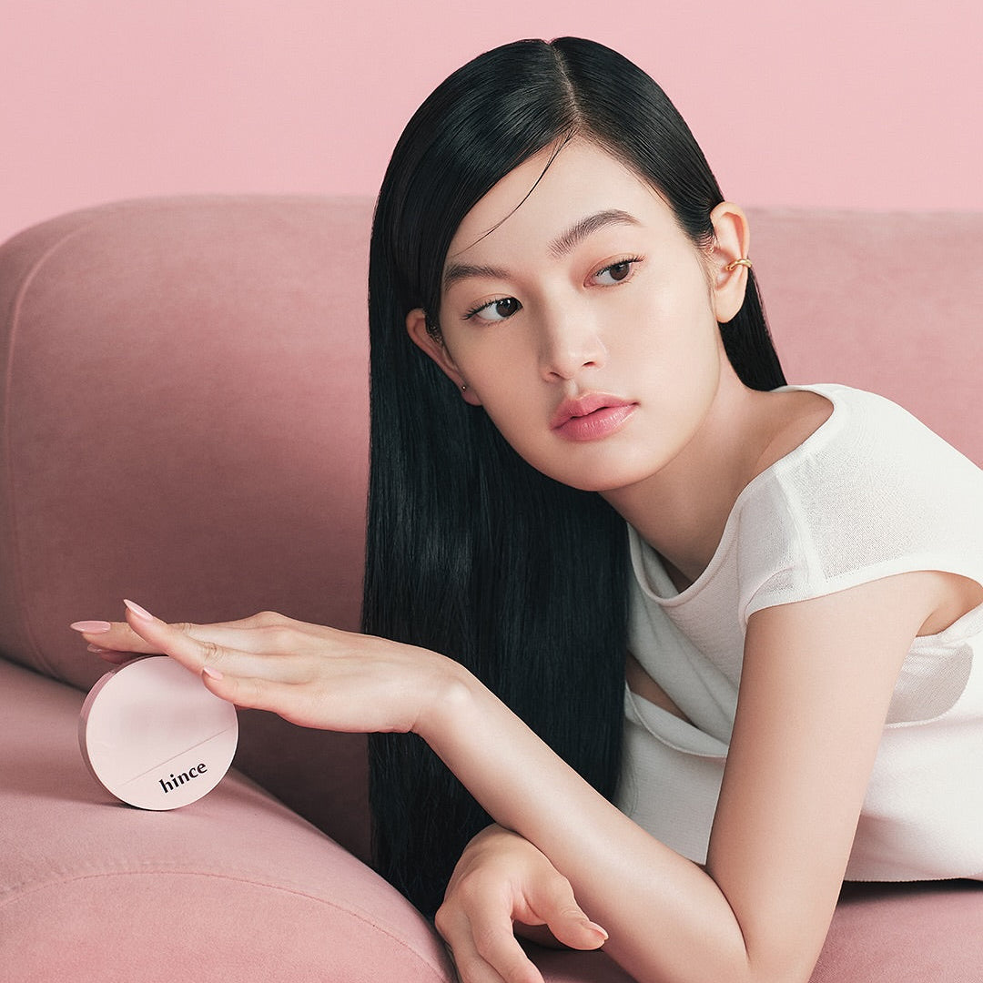Model holding HINCE Cover Master Pink Cushion on a pink sofa
