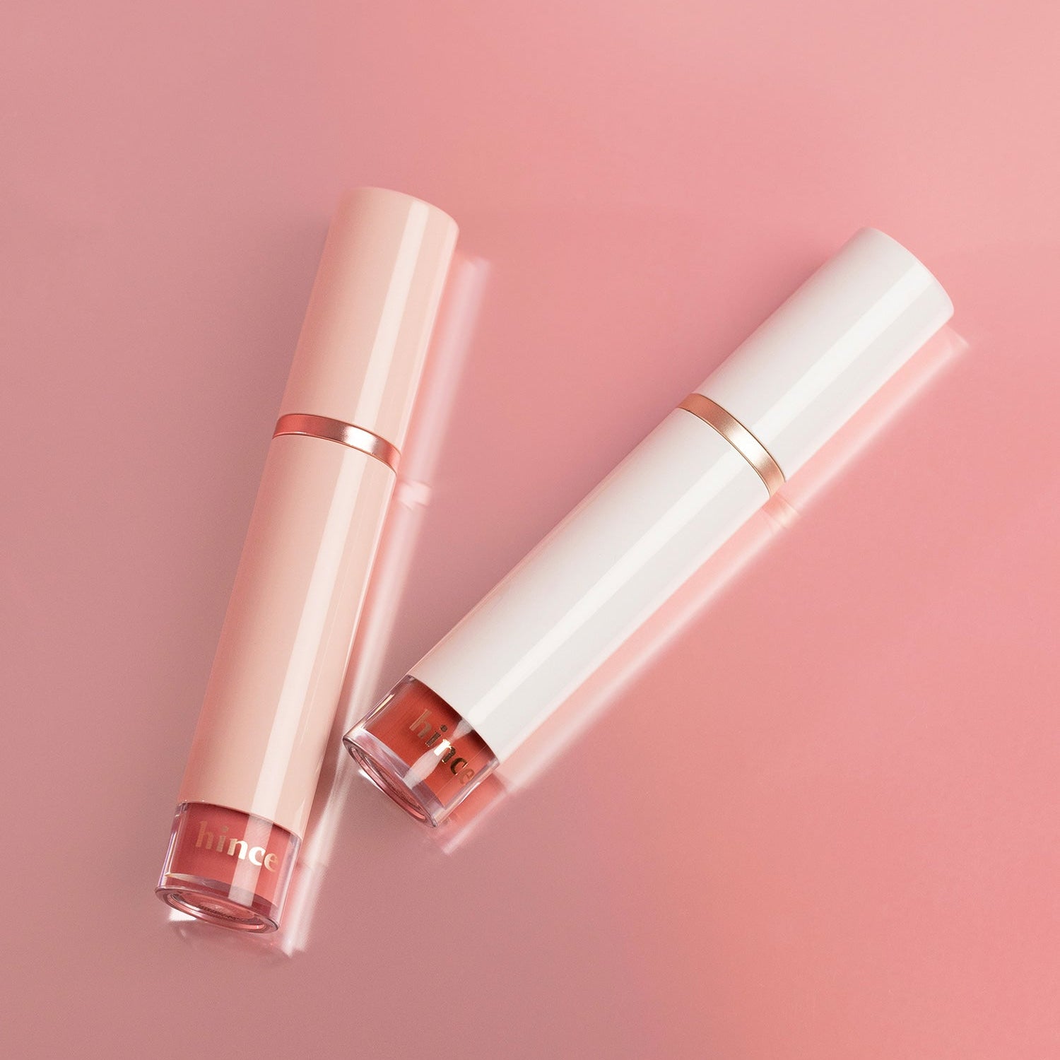 HINCE Mood Enhancer Water Liquid Glow in elegant peach and white packaging on a pink background