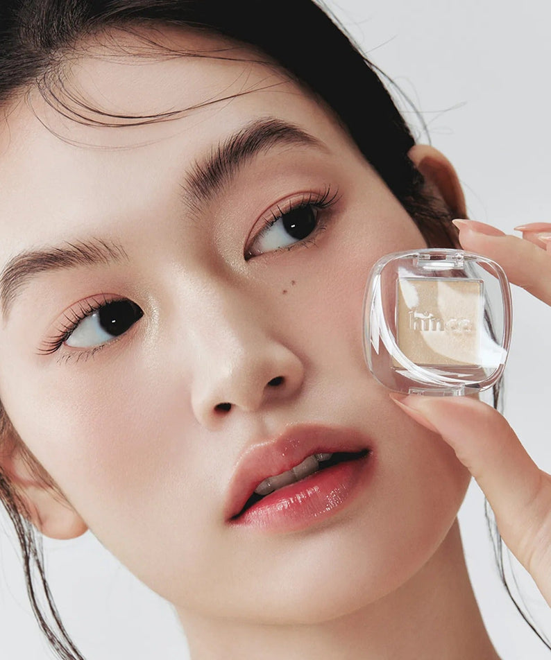 Close-up of woman showcasing HINCE Single Eyeshadow, highlighting eye makeup with a focus on natural beauty and elegance.