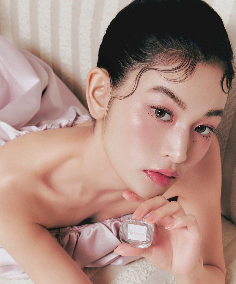 Model holding HINCE Single Eyeshadow, showcasing makeup application