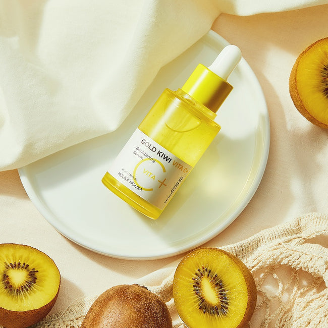 HOLIKA HOLIKA Gold Kiwi Vita C+ Brightening Serum 45ml with sliced kiwi fruits on a plate