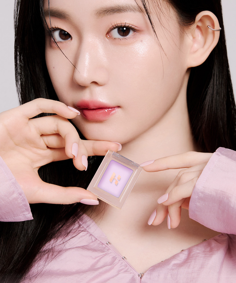 Model holding HOLIKA HOLIKA My Favorite Peace Concealer, showcasing the product's sleek design and packaging.