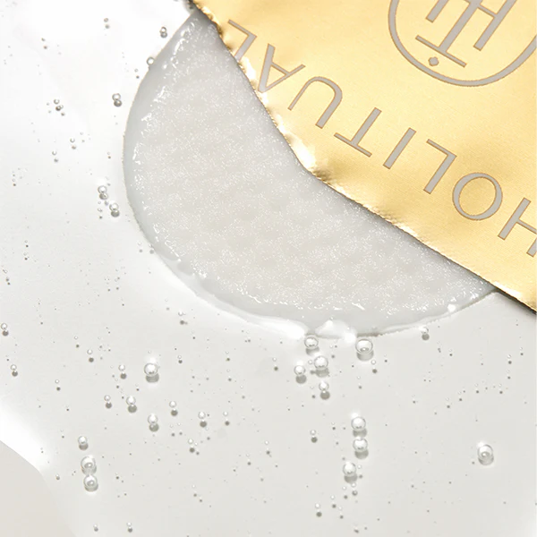 Close-up of HOLITUAL Radiance Resurfacing Peel texture with gold packaging