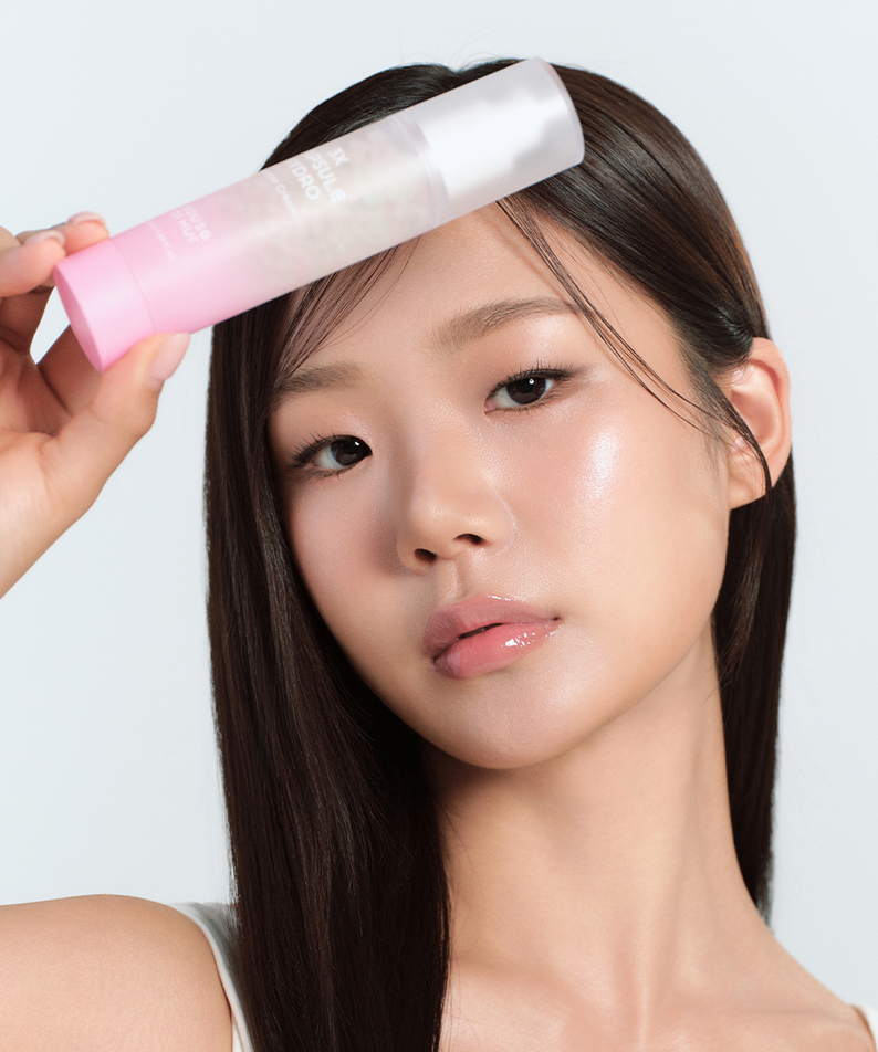 Model holding HOUSE OF HUR 3X Capsule Hydro Booster Cream 50ml, showcasing glowing skin and beauty benefits.