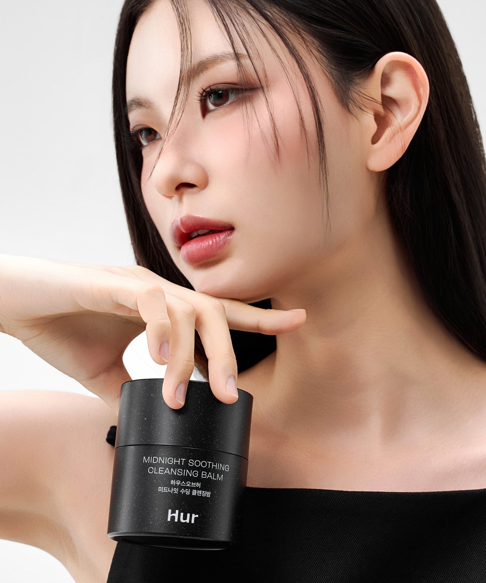 Model holding HOUSE OF HUR Midnight Soothing Cleansing Balm