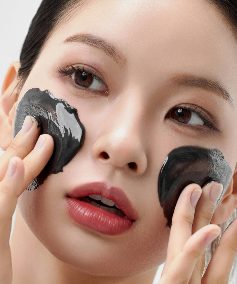 Woman applies HOUSE OF HUR Midnight Soothing Cleansing Balm to her face for a refreshing skincare routine.