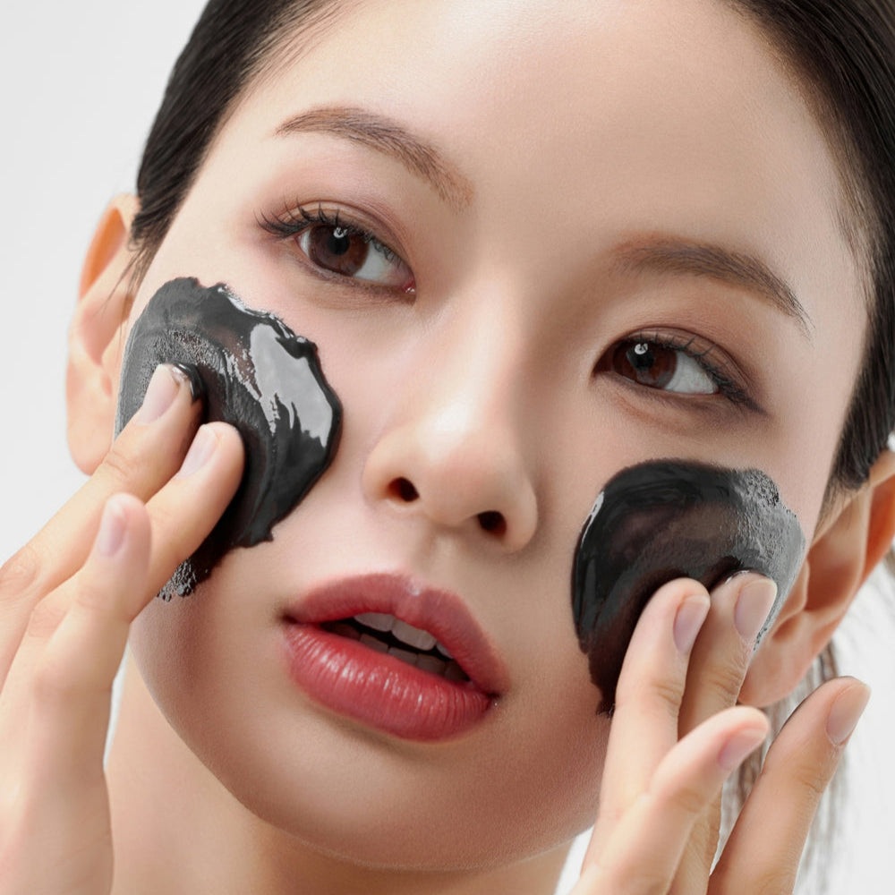 Woman applies HOUSE OF HUR Midnight Soothing Cleansing Balm to her face for a refreshing skincare routine.