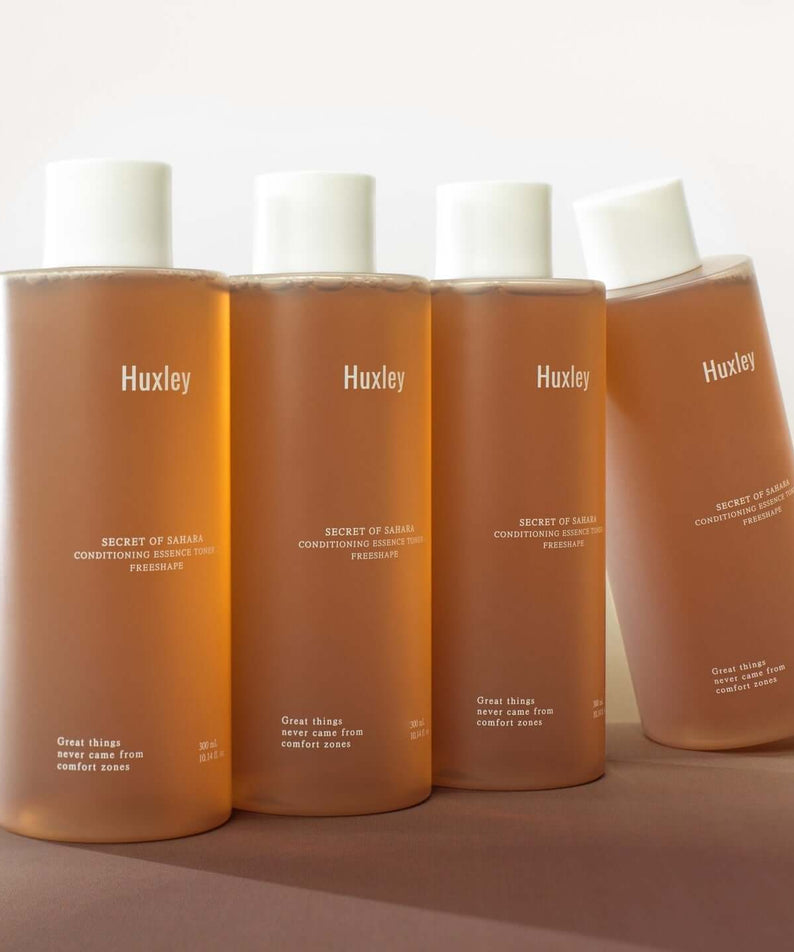 HUXLEY Conditioning Essence Toner Preshape bottles in a row, showcasing the skincare product