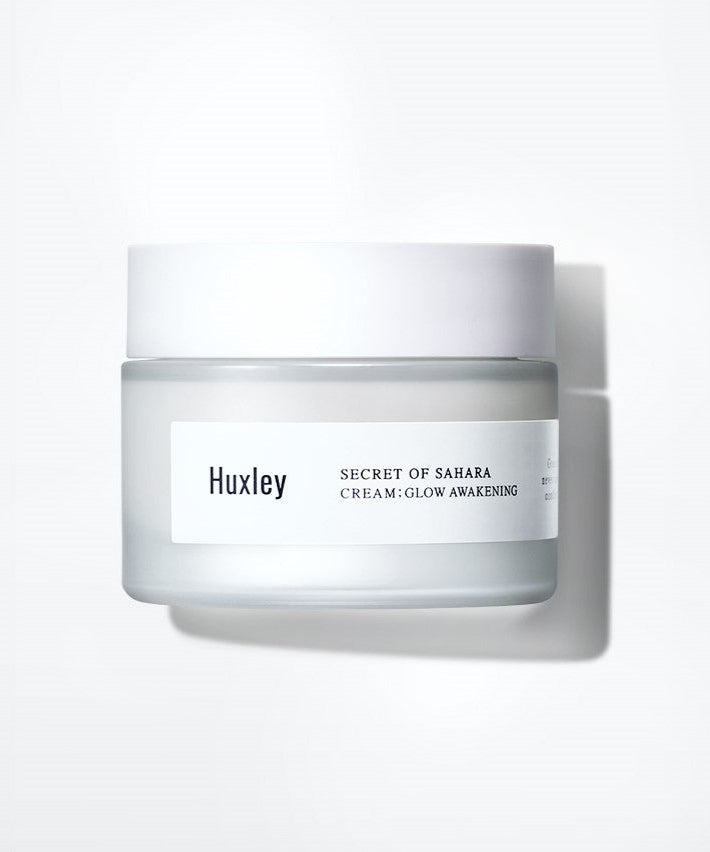 HUXLEY Cream Glow Awakening 50ml in a frosted jar with white lid, offering skin moisturizing and brightening benefits for a radiant glow.