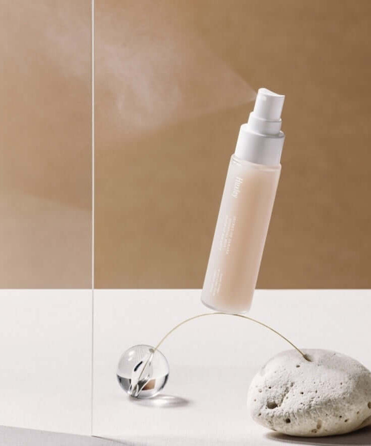 HUXLEY Essential Mist Sense Of Balance bottle showcased on minimalist stone and glass background.