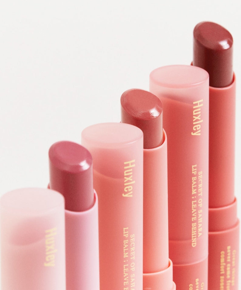 Assortment of HUXLEY Lip Balm Leave Behide in various shades