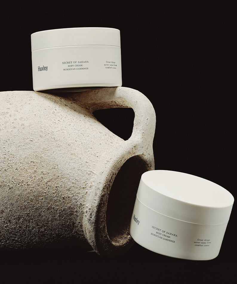 HUXLEY Moroccan Gardener Body Cream 200ml jars displayed with rustic pottery