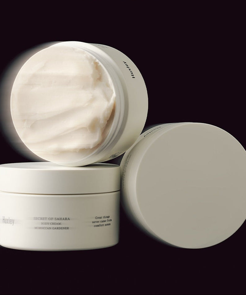 HUXLEY Moroccan Gardener Body Cream 200ml in beige jar with cream texture displayed on a dark background.