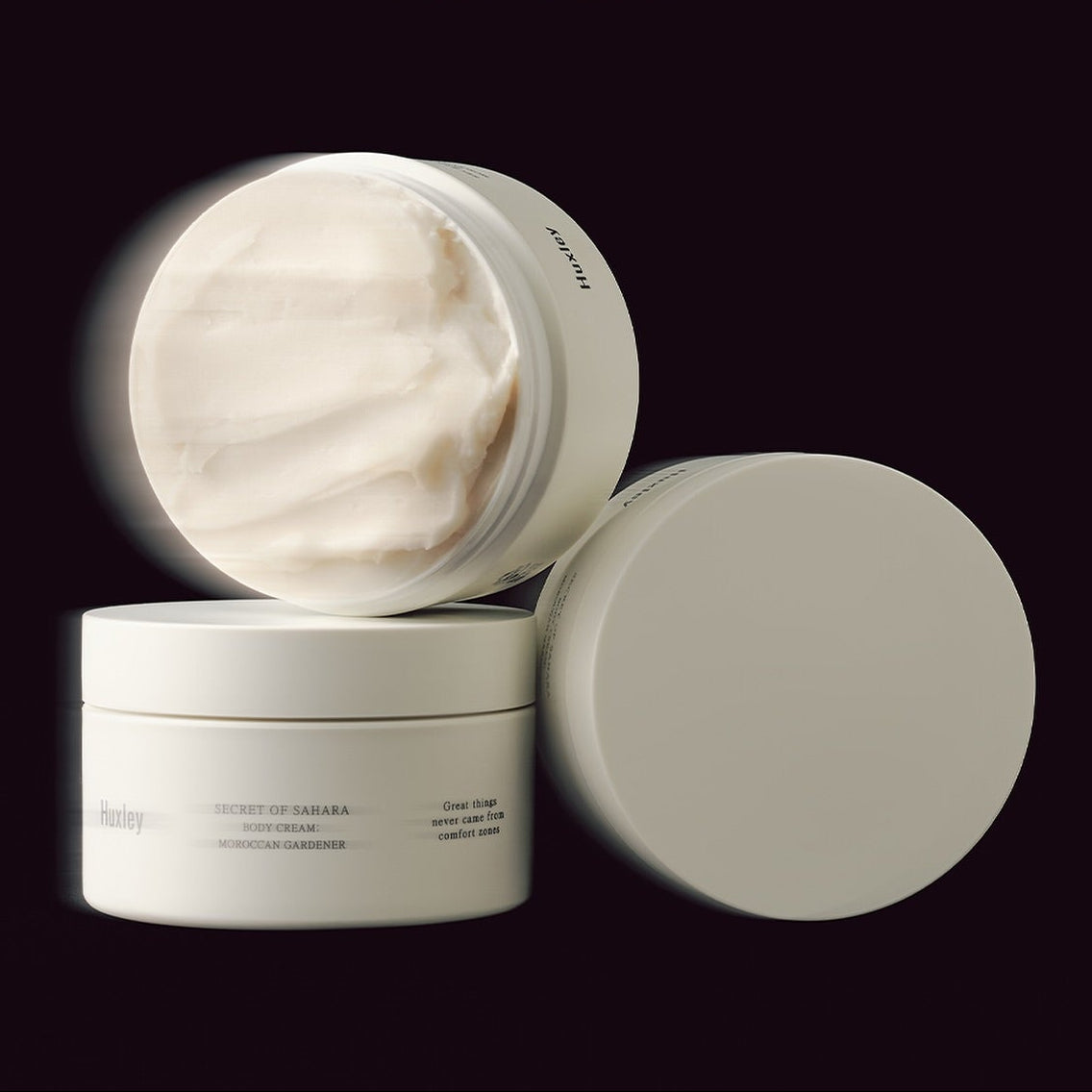 HUXLEY Moroccan Gardener Body Cream 200ml in beige jar with cream texture displayed on a dark background.