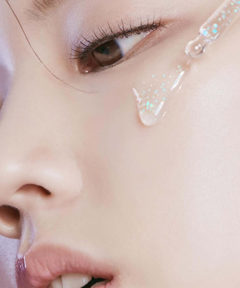 Close-up application of HUXLEY Priming Essence Rediance Layer on skin for enhanced radiance and hydration.