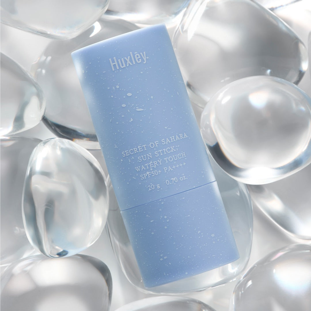 HUXLEY Sun Stick Watery Touch 20g on crystal background