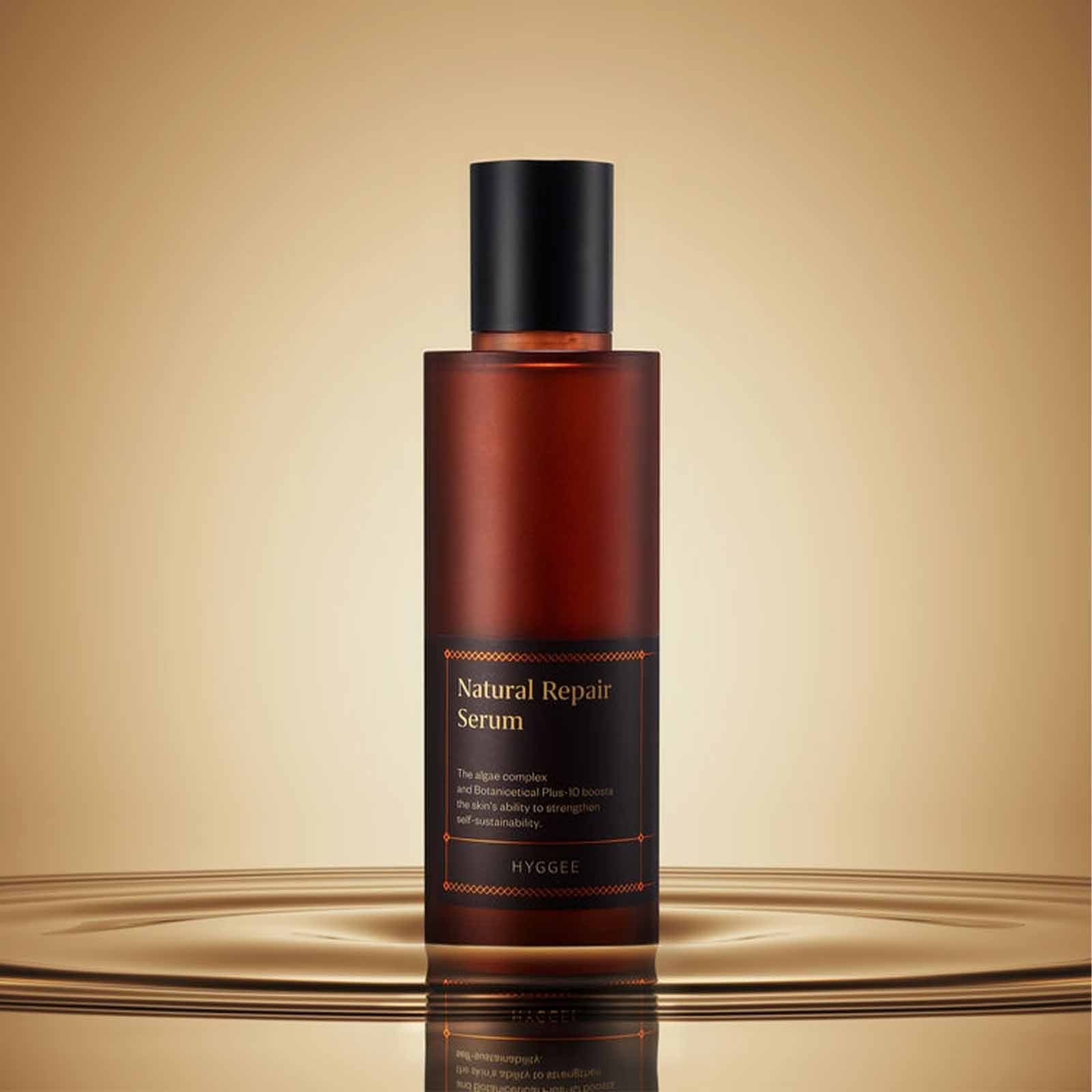HYGGEE Natural Repair Serum 120ml bottle on a stylish reflective surface.