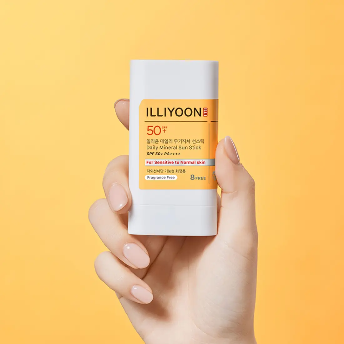 Hand holding ILLIYOON Daily Weaponless Sun Stick 20g against an orange background.